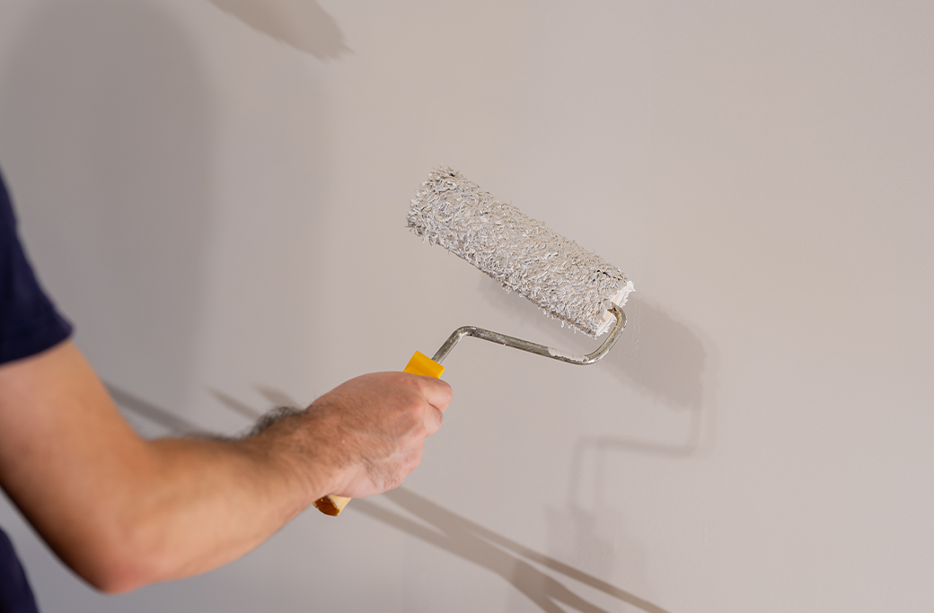 Professional painter applying interior wall paint in a Virginia Beach home